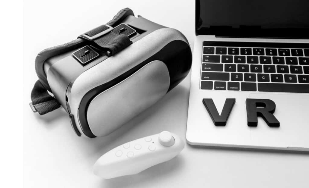 VR equipment next to a laptop with 'VR' text on the keyboard