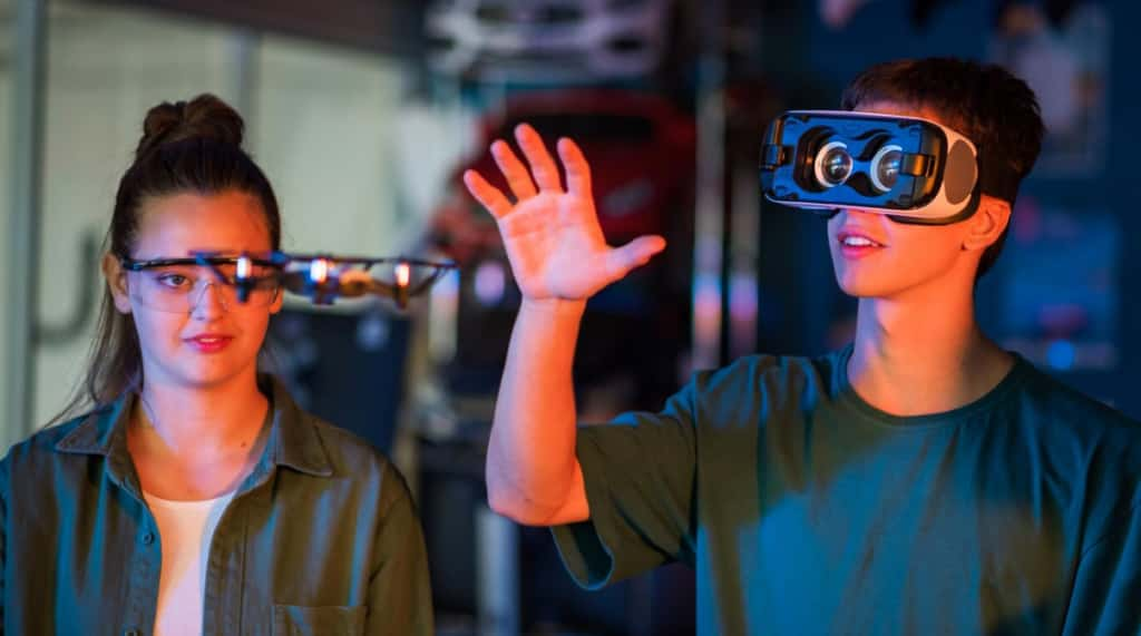 Two people experimenting with VR, one wearing a headset