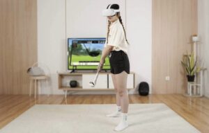 Girl in VR glasses plays golf at home