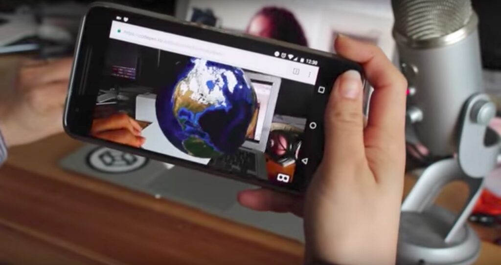 Hand holding smartphone with VR application