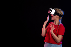 A woman expresses surprise while using a VR headset against a black background